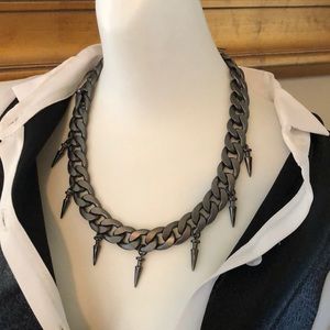 Gun metal chain necklace with spike like details.
